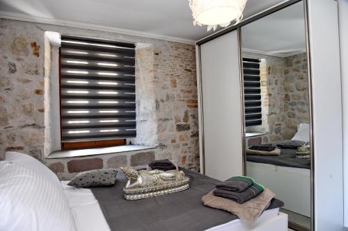 a bedroom with a mirror and a bed with towels at Lana & Ena Apartments in Kotor