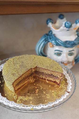 a piece of cake on a plate on a table at Ines bed and breakfast in Giardini Naxos