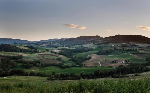a view of a green valley with mountains at La Locanda del Borgo in Torrechiara