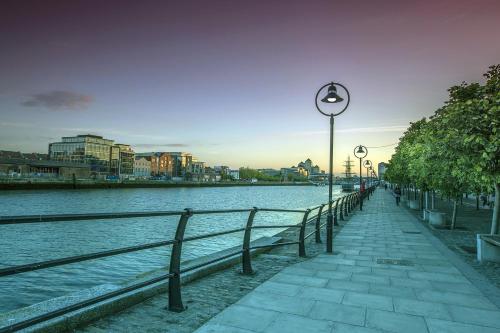 a street light next to a body of water at Leonardo Hotel Dublin Parnell Street in Dublin