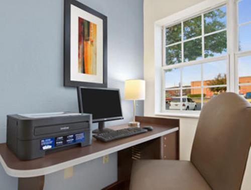 an office with a desk with a computer and a printer at Microtel Inn & Suites - Greenville in Greenville
