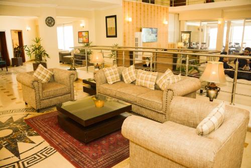 a living room with two couches and a coffee table at Holiday Grand Resort Bhurban in Murree