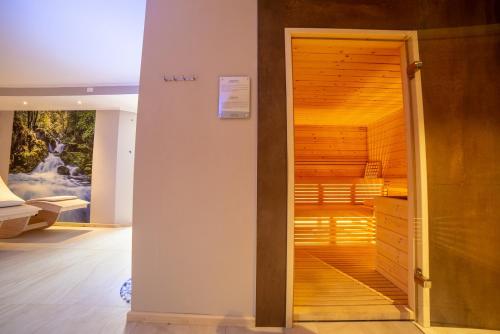 a closet with a wooden door in a room at Caminetto Mountain Resort in Lavarone