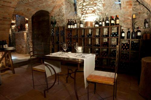 a table in a room with bottles of wine at Tenuta La Cascinetta in Buriasco