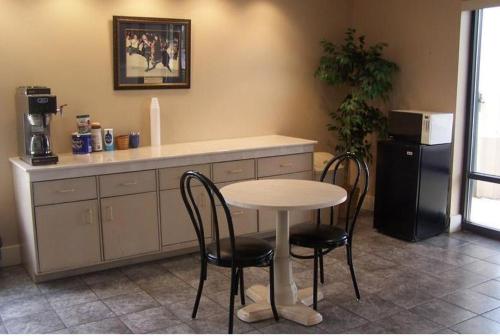 a kitchen with a table and two chairs and a refrigerator at Celebration Inn in Lewisburg