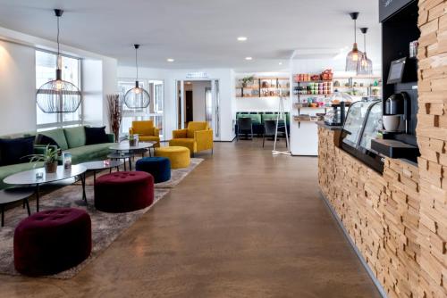 a lobby of a store with tables and chairs at 201 Hotel in Reykjav&iacute;k