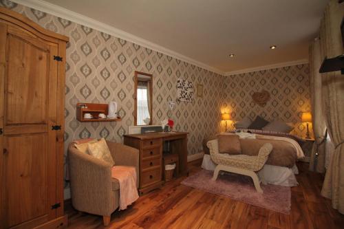 a bedroom with a bed and a desk and a chair at Donnybrook Hall in Dublin