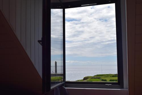 a window with a view of the ocean at Le Clos de la Pointe Saint-Mathieu in Plougonvelin
