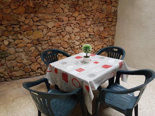 a table with chairs and a table with a plant on it at Le Malte House St. Julians in St Julian's