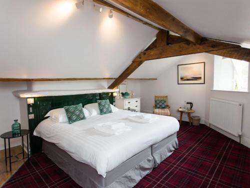 a bedroom with a large bed in a attic at Lancrigg in Grasmere