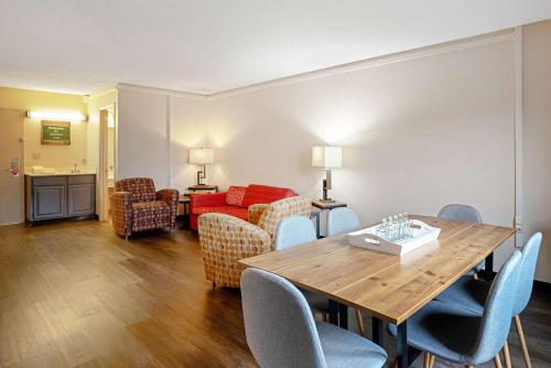 a living room with a wooden table and chairs at Quality Inn Frontier at US Hwy 30 in Clinton