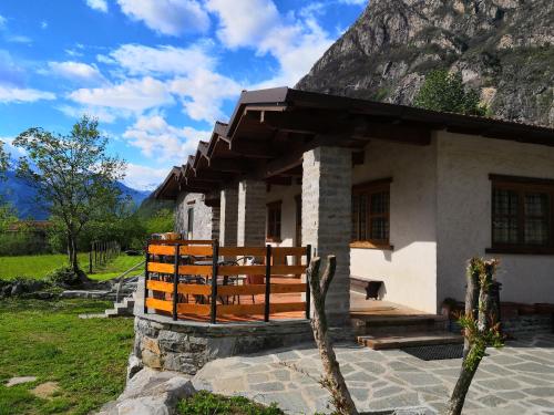 a small house in front of a mountain at Agriturismo Val Codera in Verceia