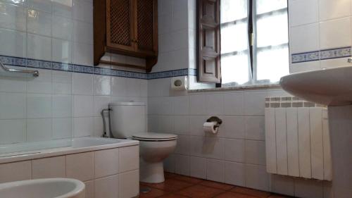 a bathroom with a toilet and a sink at Casa Belarmina in Cangas de Onís