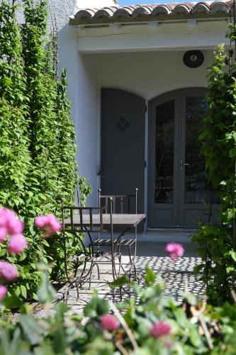 a table and chairs sitting in front of a door at Hôtel Villa Glanum et Spa in Saint-Rémy-de-Provence