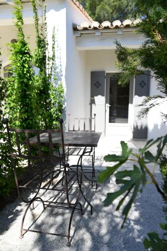a bench sitting in front of a house at Hôtel Villa Glanum et Spa in Saint-Rémy-de-Provence