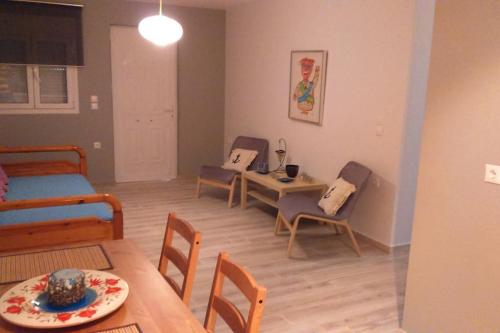 una sala de estar con mesa y sillas y una habitación en Villa Sunset, en Paralia Vrachou