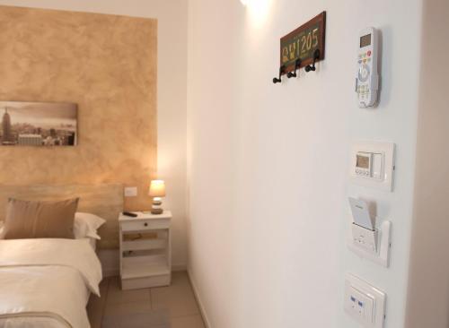a bedroom with a bed and a sign on the wall at Le Suites - di fronte Ospedale Sacro Cuore in Negrar