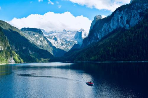 a boat on a lake in the mountains at Gosau Apartment 209 in Gosau