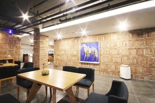 a conference room with a wooden table and chairs at Brown Dot Hotel Seomyeon in Busan