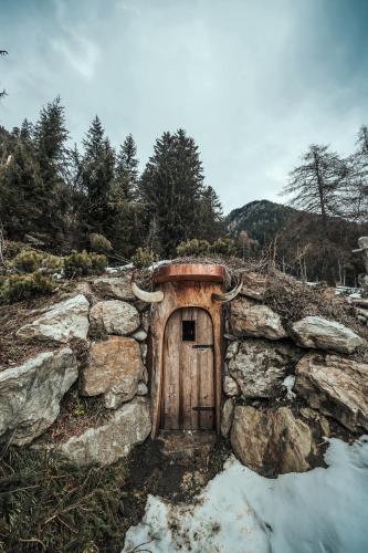 a small door in a stone wall with horns at Naturhotel Lüsnerhof in Luson