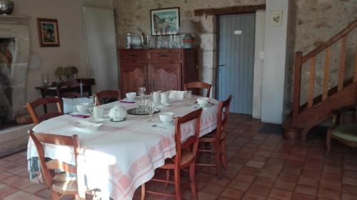 a dining room with a table with a white table cloth at lembaudie in Saint-Privat-des-Prés