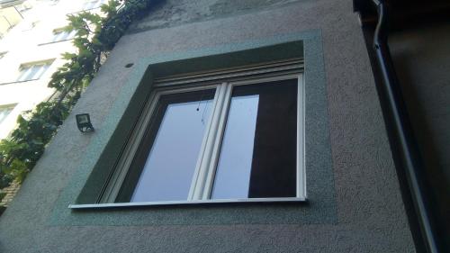 a window on the side of a building at Slavija Square in Belgrade