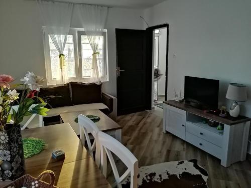 a living room with a couch and a table at Apartman Nikocevic in Dobra Voda