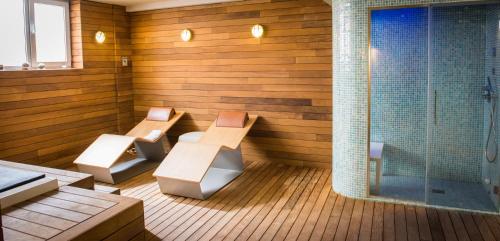 un sauna avec deux bancs et une douche dans l'établissement Lagaya Apartaments & Spa, à Valderrobres