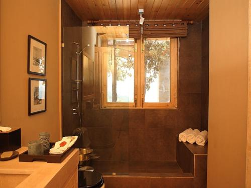 a bathroom with a shower and a window at Mary Budden Estate in Almora