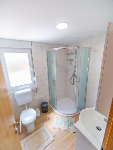 a bathroom with a shower and a toilet and a sink at Mobile House Fantina in Sveti Filip i Jakov