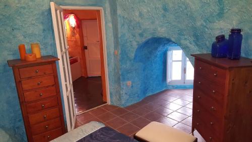 a room with a dresser and a room with a hallway at Casa-Cueva Nijar in Níjar