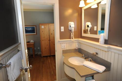 a bathroom with a sink and a mirror at Southampton Long Island Hotel in Southampton