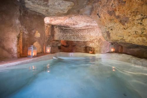 a large pool of water in a cave at "IL BOSCO" di POZZO VOLITO in Patù