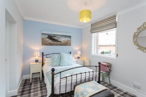 een slaapkamer met een bed en een raam bij Beach Hideaway in Lytham St Annes