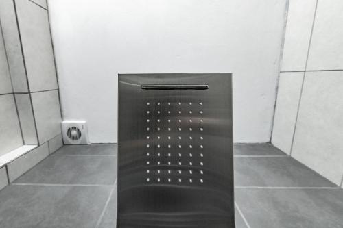 a bathroom with a black elevator in a room at Akrogiali Apartments in Barbati