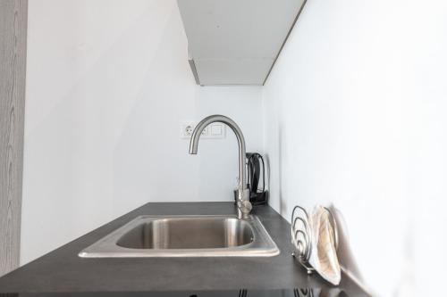 a stainless steel sink in a small kitchen at Akrogiali Apartments in Barbati