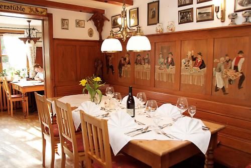 a dining room with a table with wine glasses at Hotel Restaurant Peterle in Feldberg