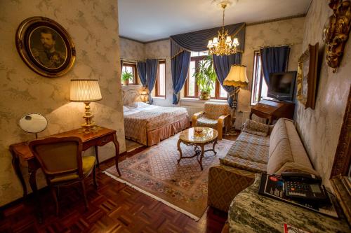 a bedroom with a living room with a bed and a couch at Park Hotel Turku in Turku
