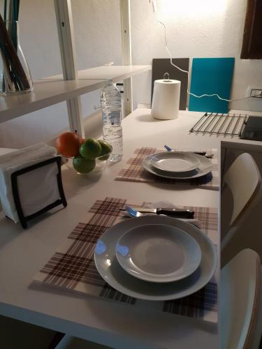 a table with two plates and a bottle of water at Minivilla a Viterbo a 5 minuti dal centro in Viterbo