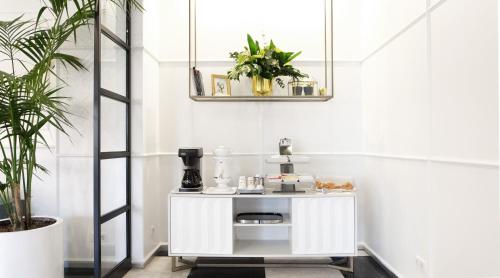 a small white table in a room with plants at Akra V - Access to Akra Antalya in Antalya