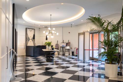 a lobby with a black and white checkered floor at Akra V - Access to Akra Antalya in Antalya