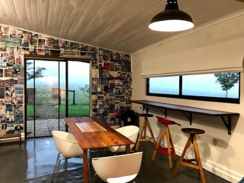 a dining room with a table and chairs at 180 at Mission House in Curryʼs Post