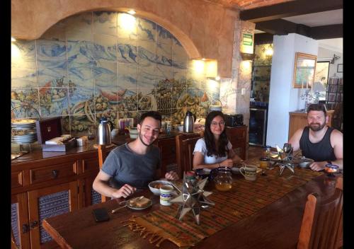 three people sitting at a table in a restaurant at Casa Estrella de la Valenciana Hotel Boutique in Guanajuato