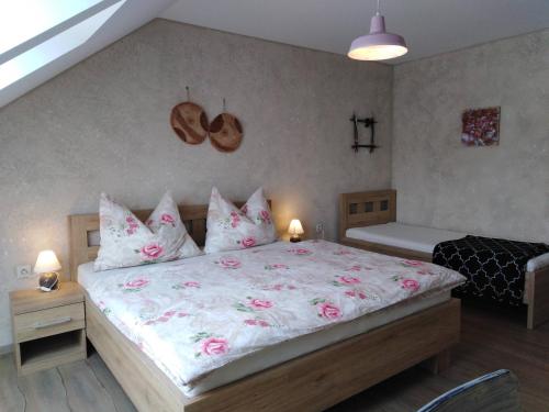 a bedroom with a large bed with pink sheets and pillows at Ubytování U Janča in Lednice