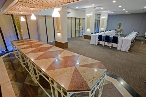a conference room with a table and chairs in it at Slaviero Curitiba Centro in Curitiba