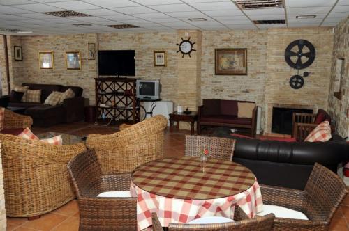 a living room with a table and chairs at Villa Eugenia in Theológos