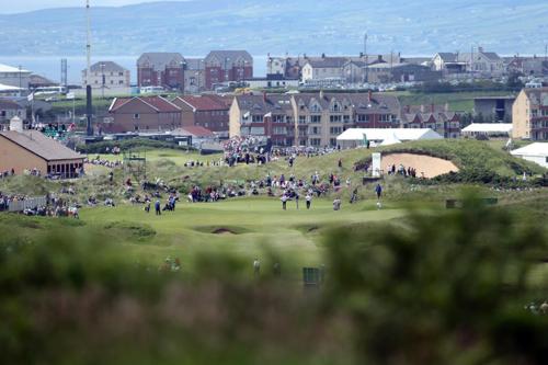 a group of people playing golf on a golf course at Links Vista Portrush in Portrush