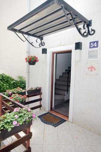 a entrance to a building with awning and stairs at Apartments Ardura in Petrovac na Moru