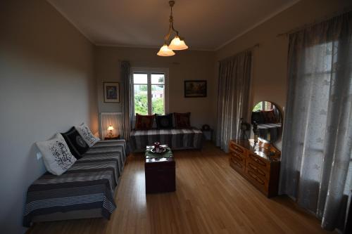 a living room with a couch and a bed at Art Flowers and Culture in Mystras