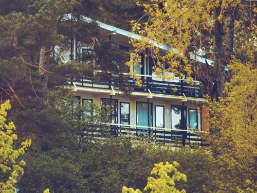 a house on top of a hill with trees at Kastytis in Nida